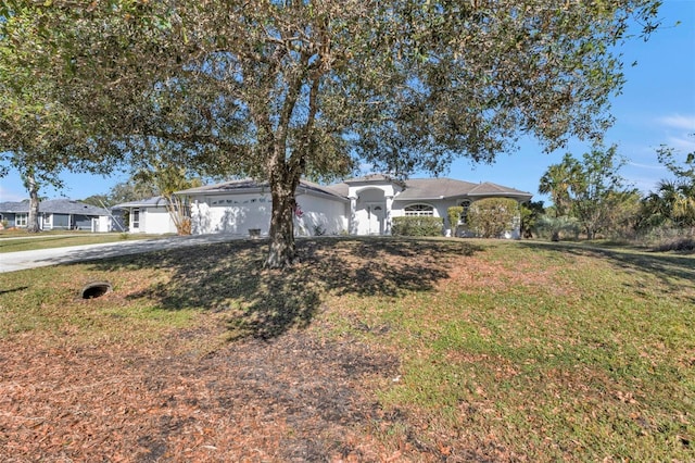 ranch-style home featuring a garage and a front lawn