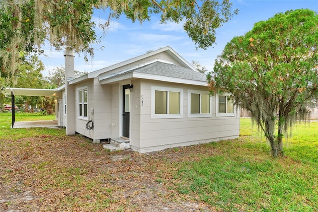 view of home's exterior with a carport