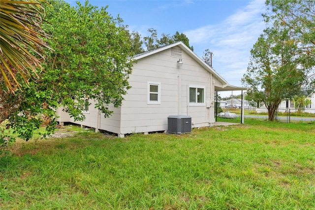 view of home's exterior with a lawn and central air condition unit