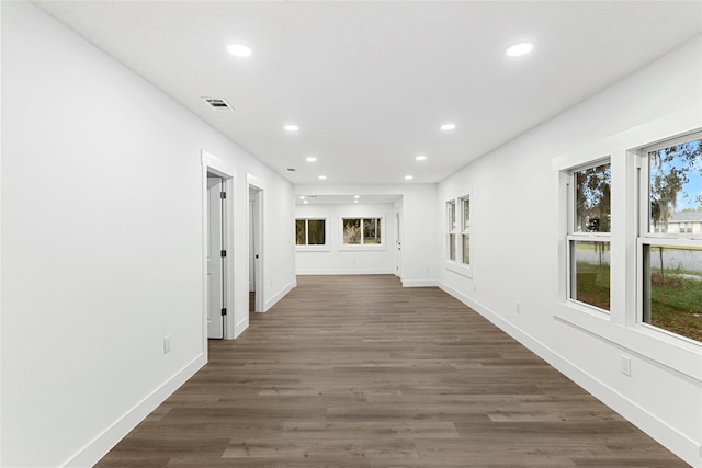 hallway featuring plenty of natural light and dark hardwood / wood-style flooring