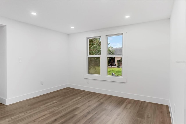 unfurnished room with hardwood / wood-style flooring