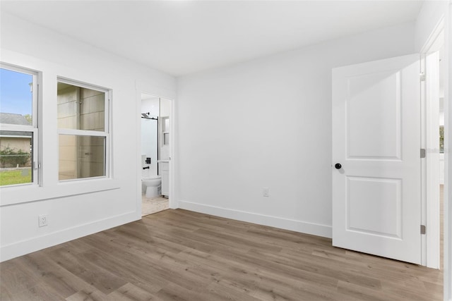 empty room with light hardwood / wood-style flooring