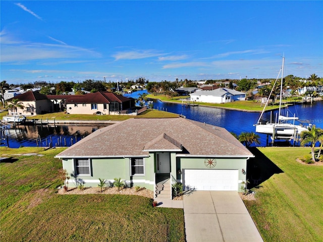 single story home featuring a garage, a front yard, and a water view