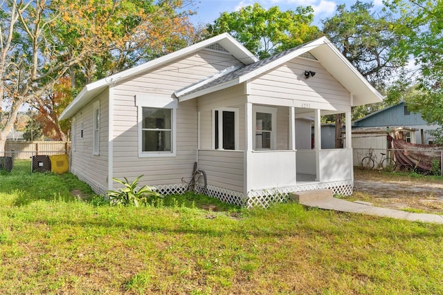 bungalow-style home with a front yard