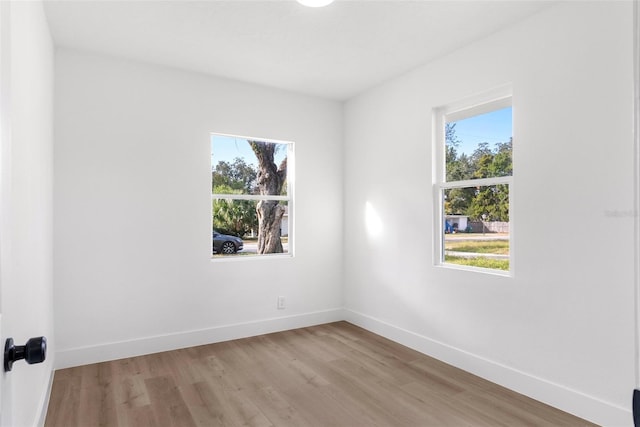 unfurnished room featuring plenty of natural light and light hardwood / wood-style floors