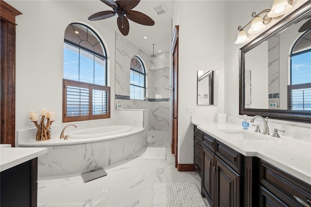 bathroom featuring vanity, ceiling fan, and plus walk in shower