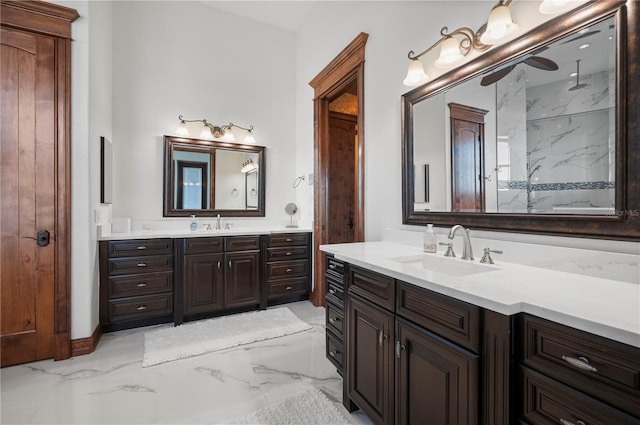 bathroom with tiled shower and vanity