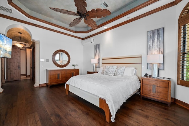 bedroom featuring an AC wall unit, crown molding, ceiling fan, a tray ceiling, and dark hardwood / wood-style flooring