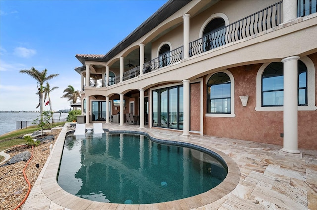 view of pool featuring a water view and a patio area