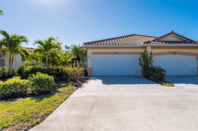 mediterranean / spanish home with a garage