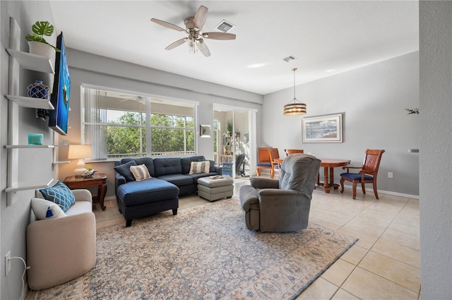 living room with ceiling fan and light tile patterned flooring