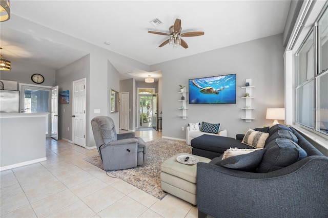 tiled living room with ceiling fan