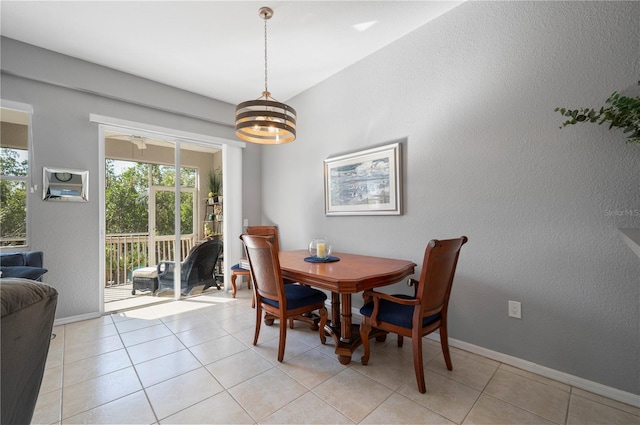 dining area with ceiling fan with notable chandelier and light tile patterned flooring