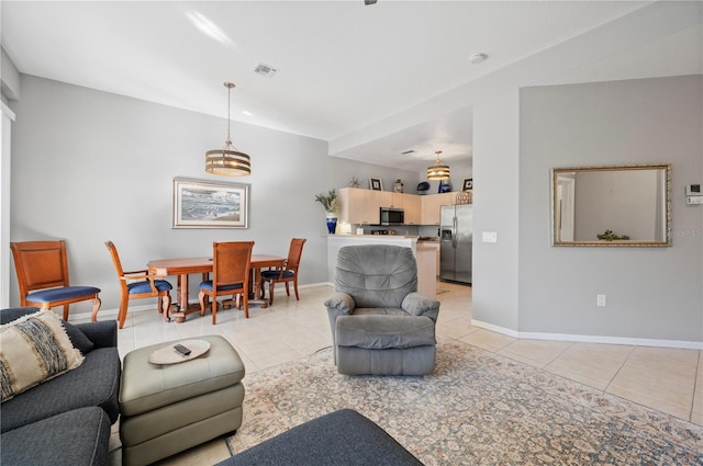 tiled living room featuring a notable chandelier