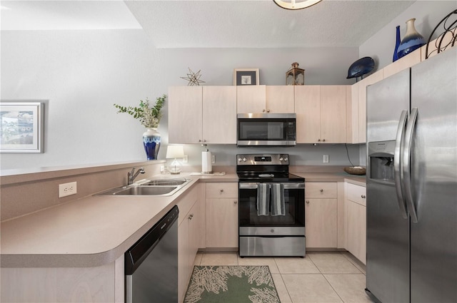 kitchen featuring sink, kitchen peninsula, a textured ceiling, light tile patterned floors, and appliances with stainless steel finishes