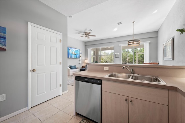 kitchen featuring stainless steel dishwasher, ceiling fan with notable chandelier, sink, pendant lighting, and light tile patterned floors