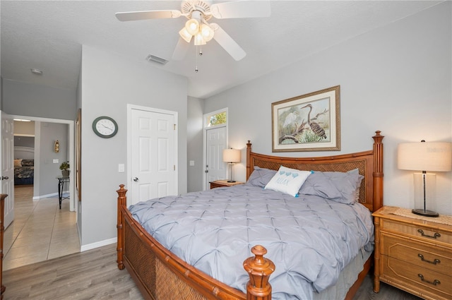 bedroom with ceiling fan and hardwood / wood-style flooring