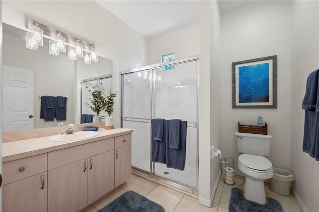 bathroom with tile patterned floors, vanity, toilet, and an enclosed shower