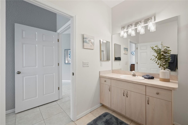 bathroom with tile patterned flooring and vanity