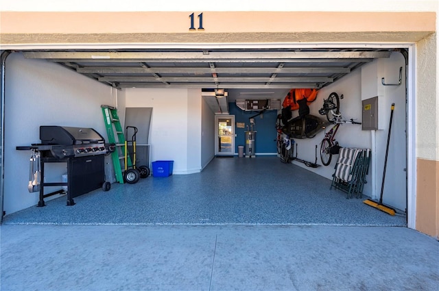 garage featuring electric water heater and electric panel