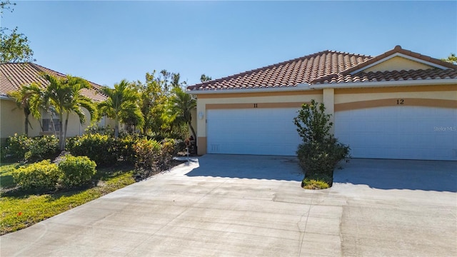 mediterranean / spanish-style house with a garage