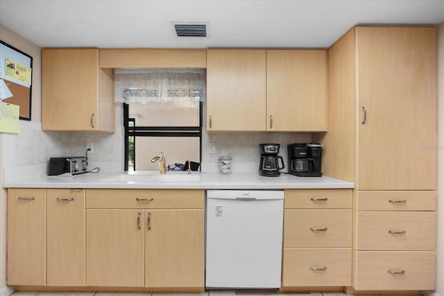 kitchen with light brown cabinets, white dishwasher, tasteful backsplash, and sink