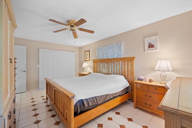 bedroom with a textured ceiling and ceiling fan