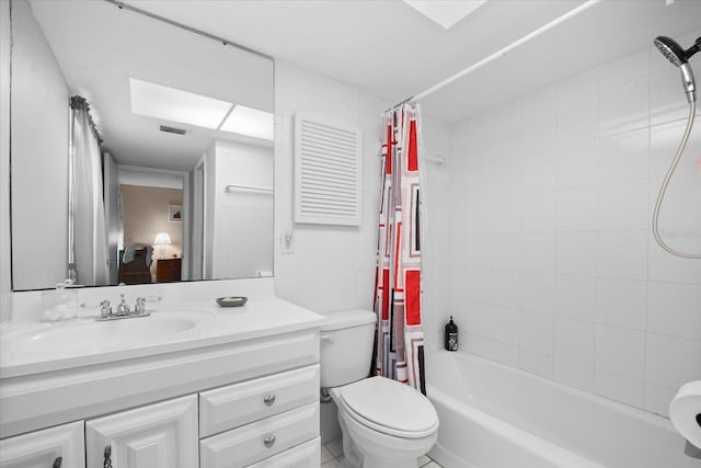 full bathroom featuring tile patterned flooring, vanity, toilet, and shower / bathtub combination with curtain