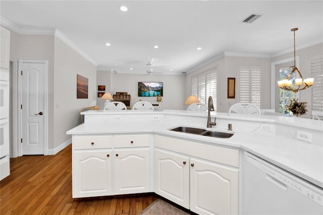 kitchen featuring white cabinetry, sink, dark wood-type flooring, kitchen peninsula, and white dishwasher