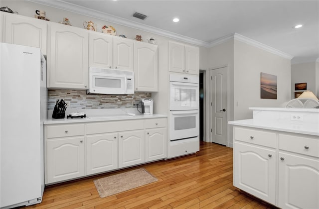 kitchen with white appliances, tasteful backsplash, white cabinetry, and light hardwood / wood-style flooring