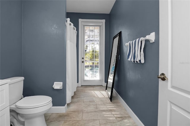 bathroom with tile patterned floors and toilet