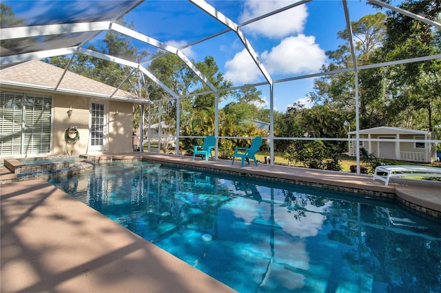 view of swimming pool with a patio area and a lanai