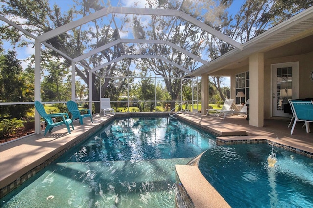 view of swimming pool with glass enclosure and a patio