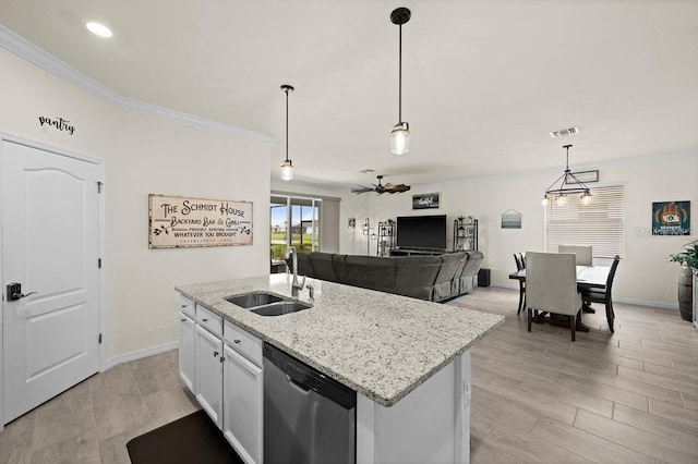 kitchen featuring a kitchen island with sink, sink, pendant lighting, dishwasher, and white cabinetry