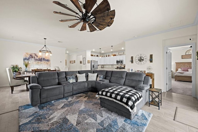 living room with ceiling fan with notable chandelier and ornamental molding