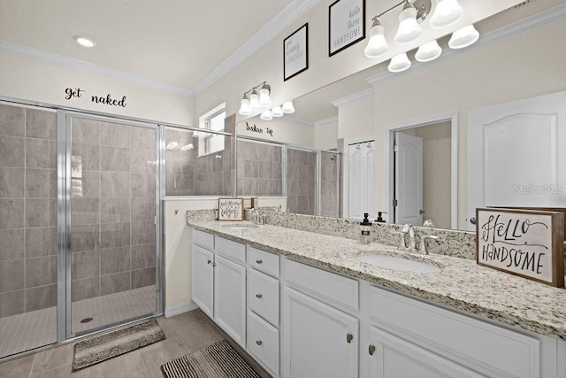 bathroom featuring hardwood / wood-style floors, vanity, a shower with door, and ornamental molding