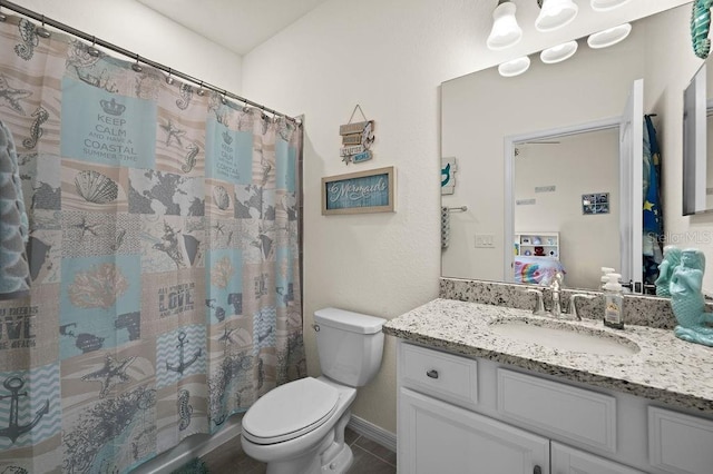 bathroom with tile patterned floors, vanity, and toilet