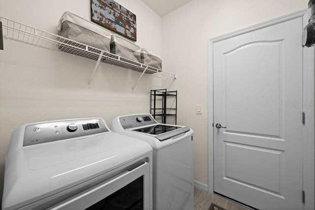 clothes washing area featuring separate washer and dryer