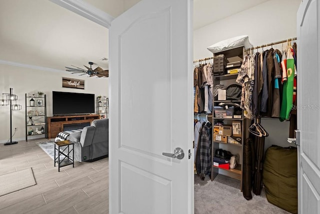 walk in closet featuring ceiling fan