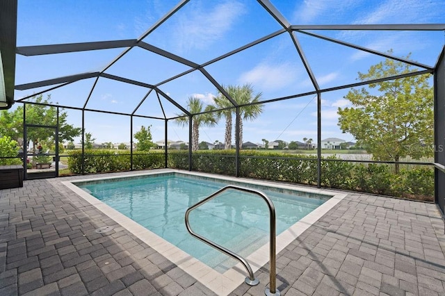 view of swimming pool featuring a patio area and a lanai