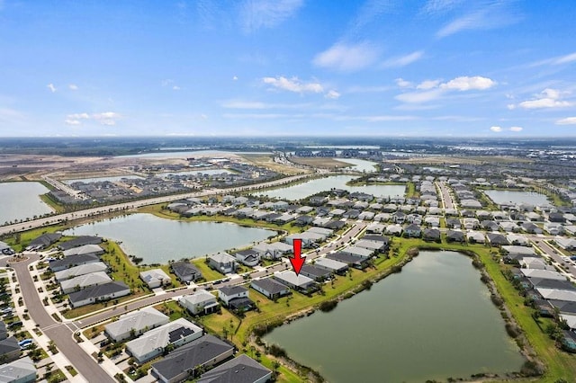 birds eye view of property with a water view