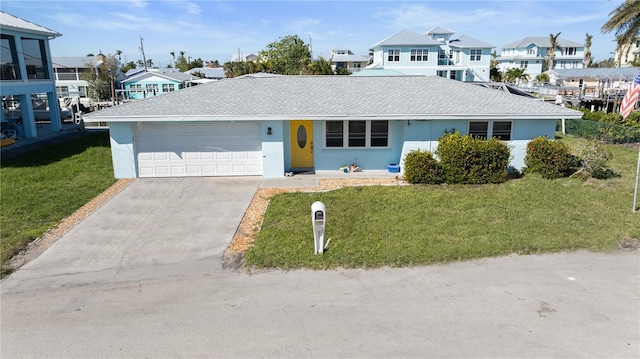 view of front of property featuring a front yard and a garage