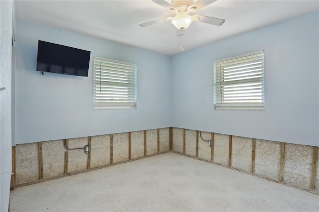 carpeted spare room with ceiling fan