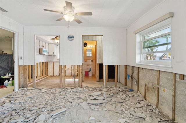 empty room with ceiling fan and ornamental molding