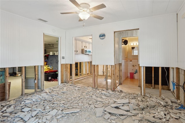 spare room with ceiling fan and crown molding