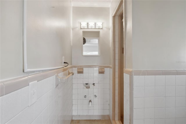 bathroom with tile walls