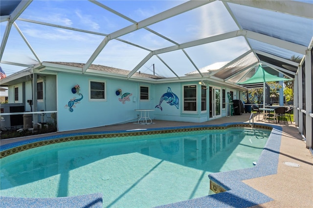 view of swimming pool featuring glass enclosure and a patio area