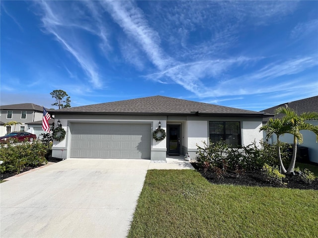 view of front of home with a garage and a front lawn