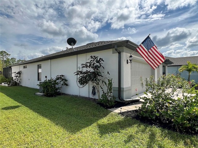 view of property exterior featuring a lawn and a garage