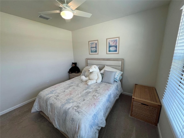 bedroom featuring dark colored carpet and ceiling fan